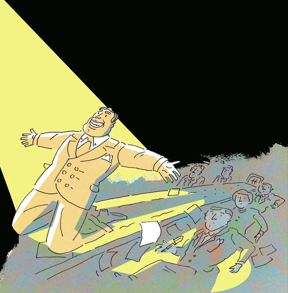 A figure in a spotlight above a crowd